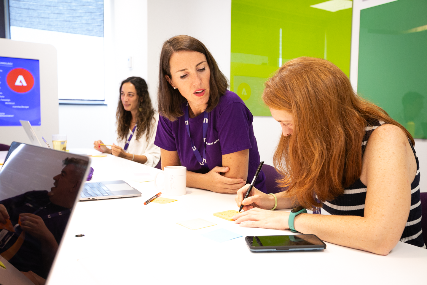 A group of female employees in a meeting room